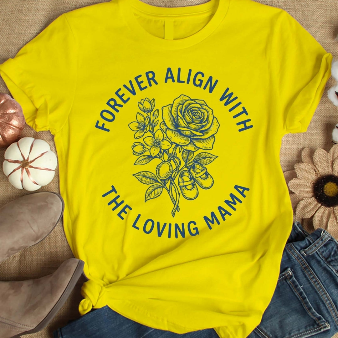 Yellow t-shirt with floral design and text on a textured surface