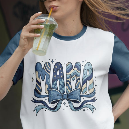 Person wearing a t-shirt with 'Mama' design and holding a drink.