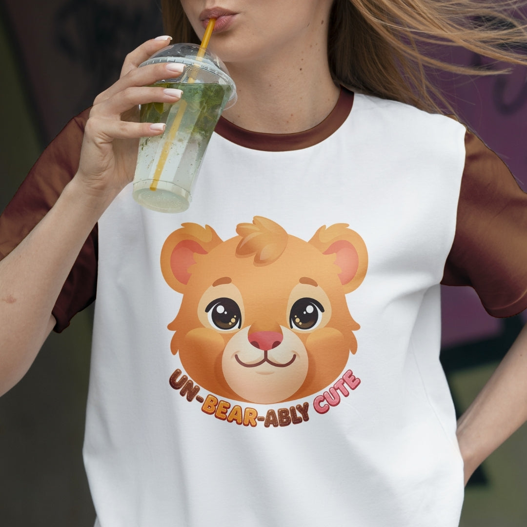 Person wearing a white sleeveless shirt with a bear graphic and text, holding a drink.