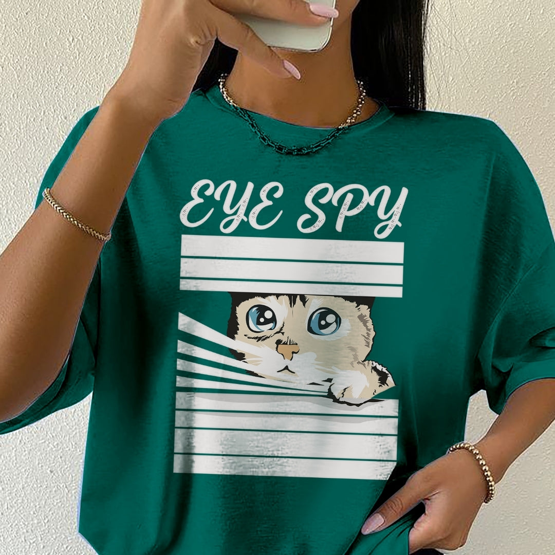 Person wearing a green t-shirt with a cat graphic and 'EYE SPY' text.