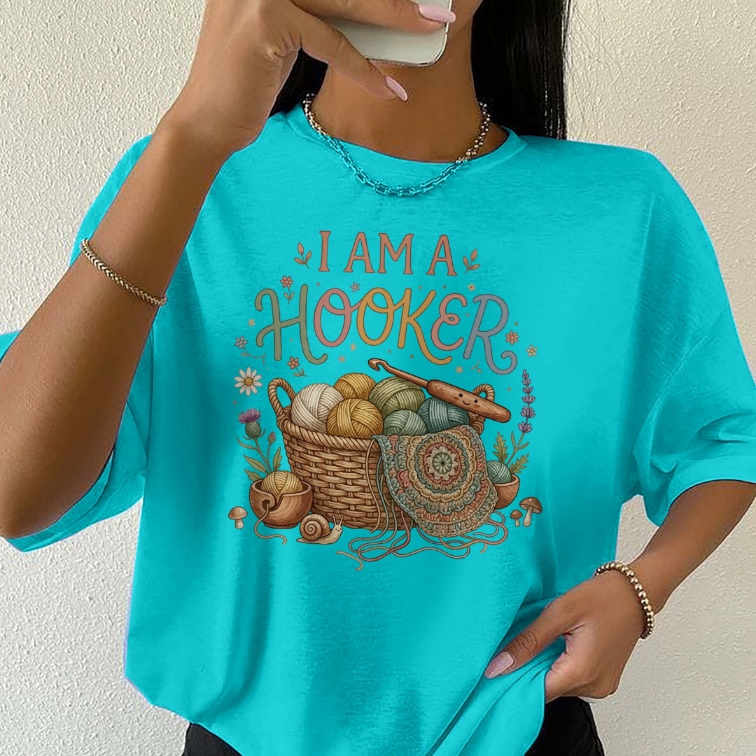 Person wearing a turquoise t-shirt with 'I AM A HOOKER' design.