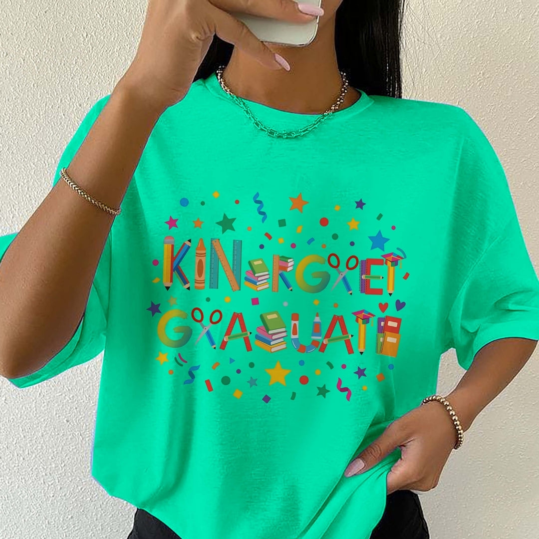 Person wearing a green t-shirt with colorful text and graphics.