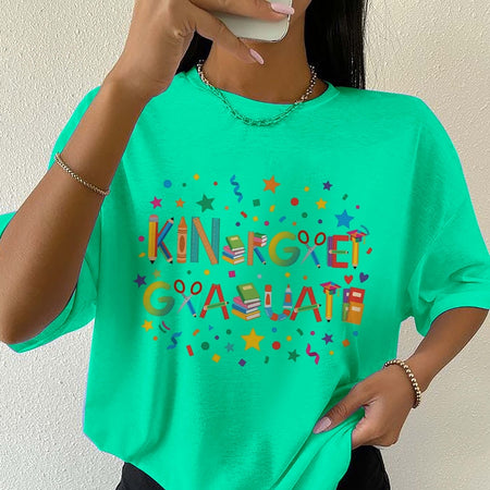 Person wearing a green t-shirt with colorful text and graphics.