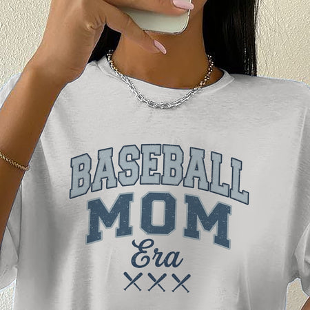 Person wearing a white t-shirt with 'BASEBALL MOM Era XXX' text.
