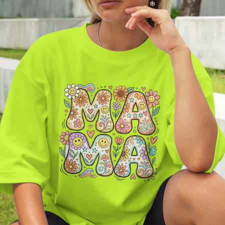 Person wearing a bright green t-shirt with colorful 'MAMA' design.