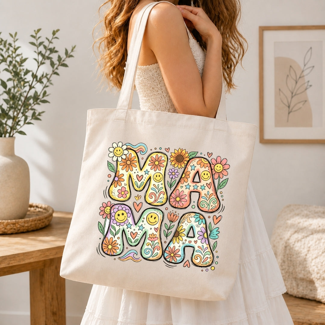 Person holding a tote bag with 'MAMA' design in a home setting
