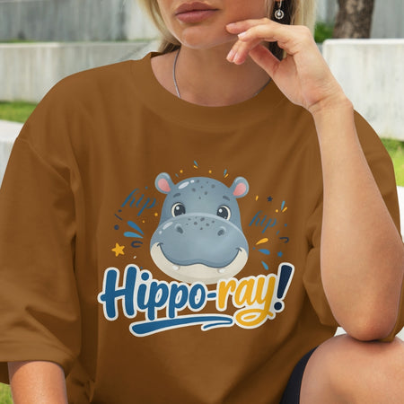 Person wearing a brown t-shirt with a hippo graphic and 'Hippo-ray!' text.