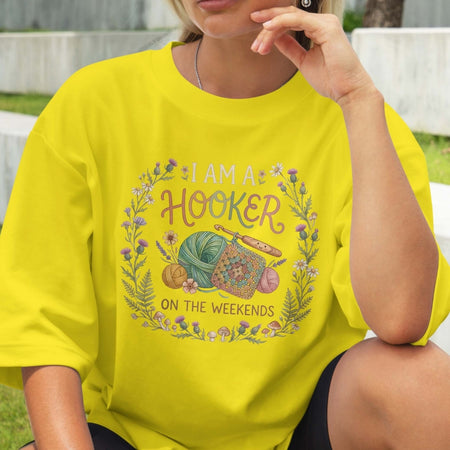 Person wearing a yellow t-shirt with a hooker-themed graphic and text.