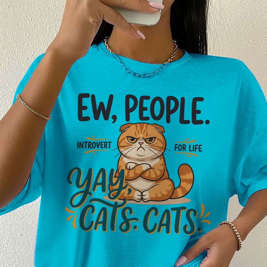 Person wearing a blue t-shirt with a cat graphic and text.
