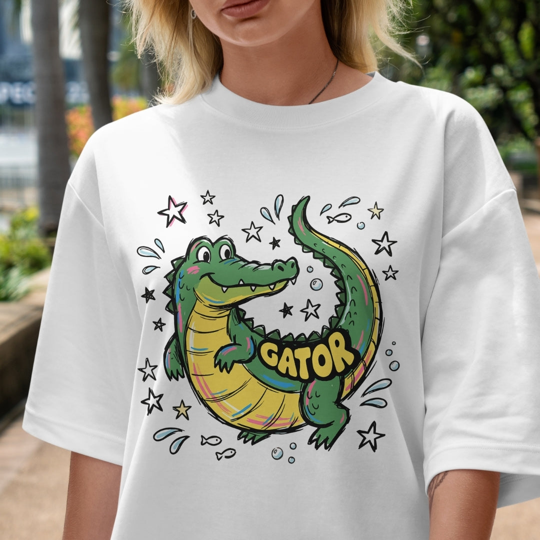 Person wearing a white t-shirt with a colorful alligator graphic and 'GATOR' text.