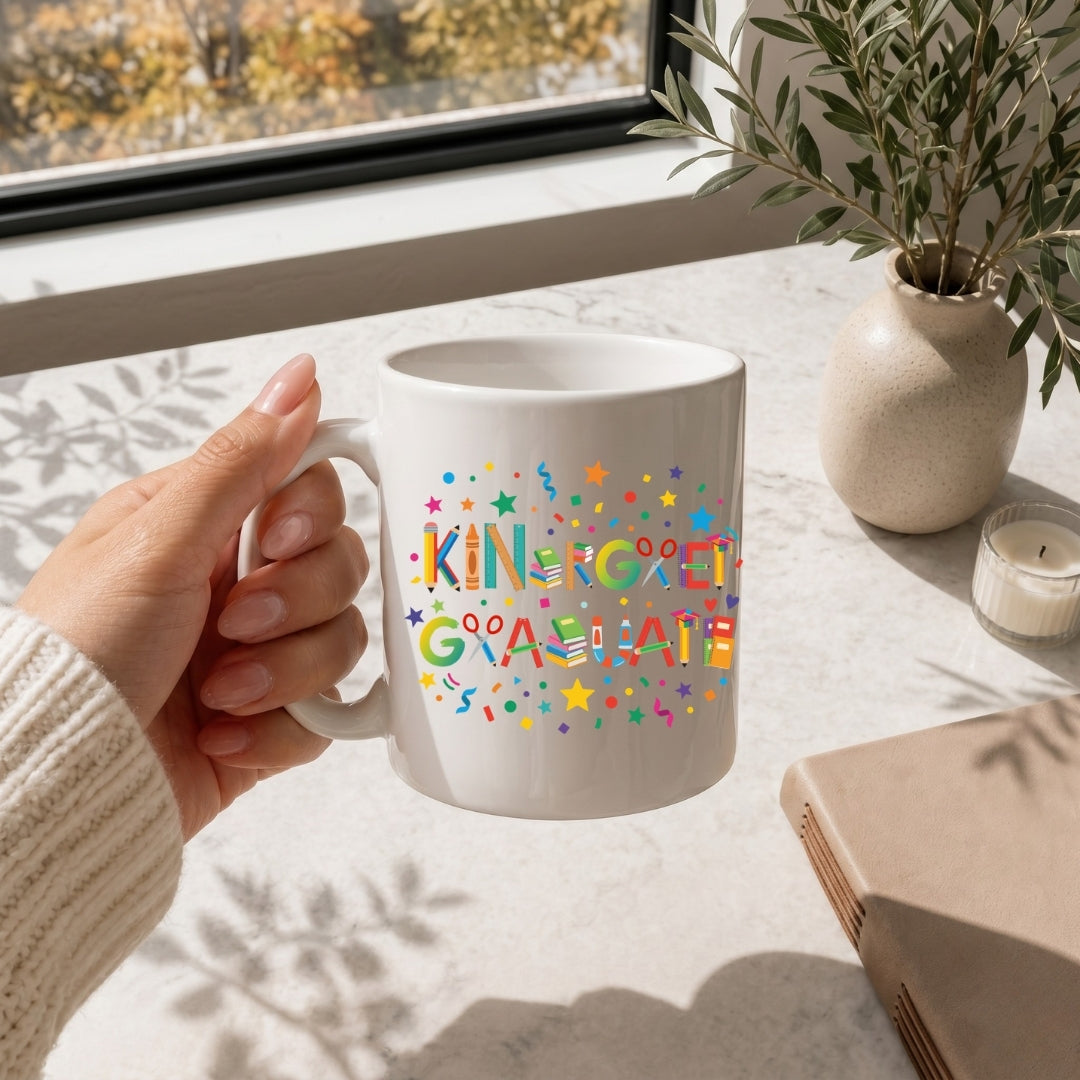 White mug with 'MAMA' text held by a hand on a table with a window and plant in the background