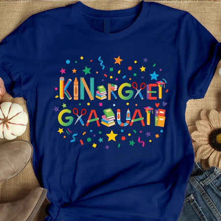 Blue t-shirt with colorful 'Kindergarten Graduate' text on a textured surface