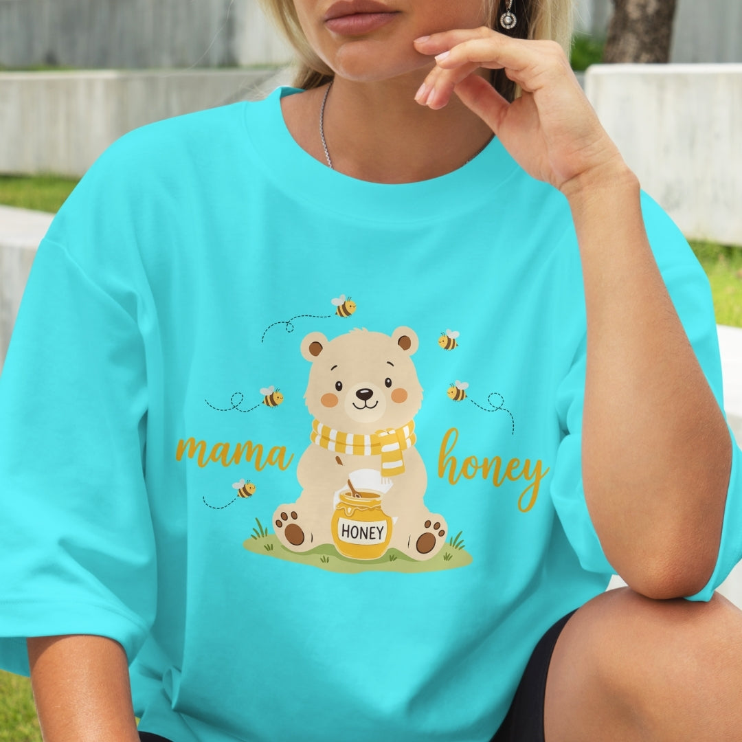 Person wearing a turquoise t-shirt with a bear graphic and 'mama honey' text.