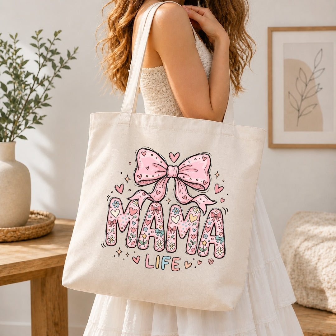 Person holding a tote bag with 'Mama Life' design in a home setting