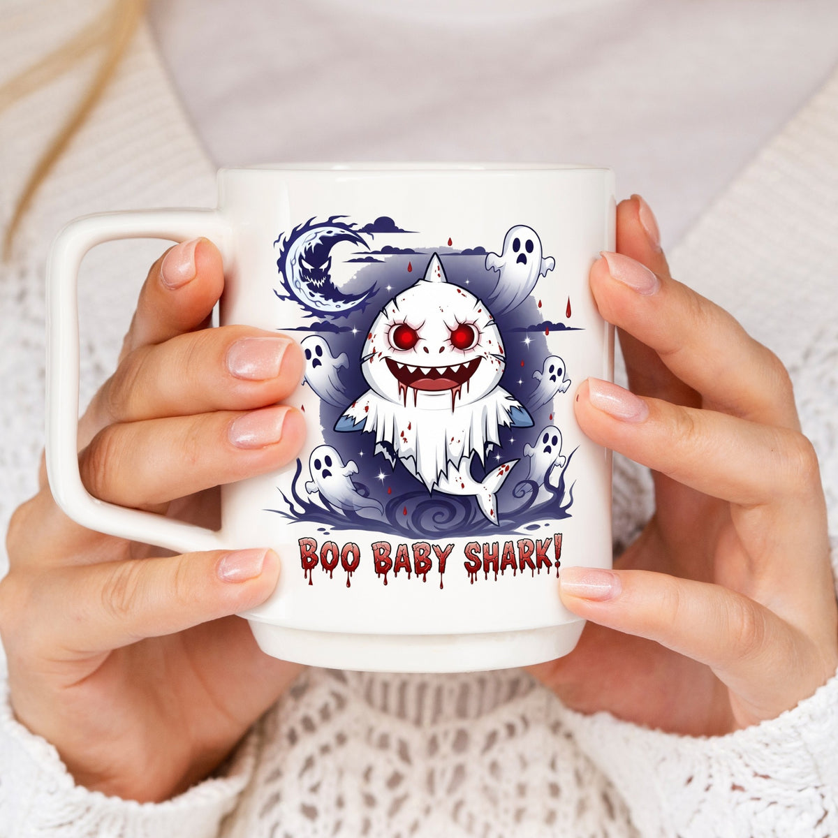 Mug with 'Boo Baby Shark' design held by a person wearing a white sweater.