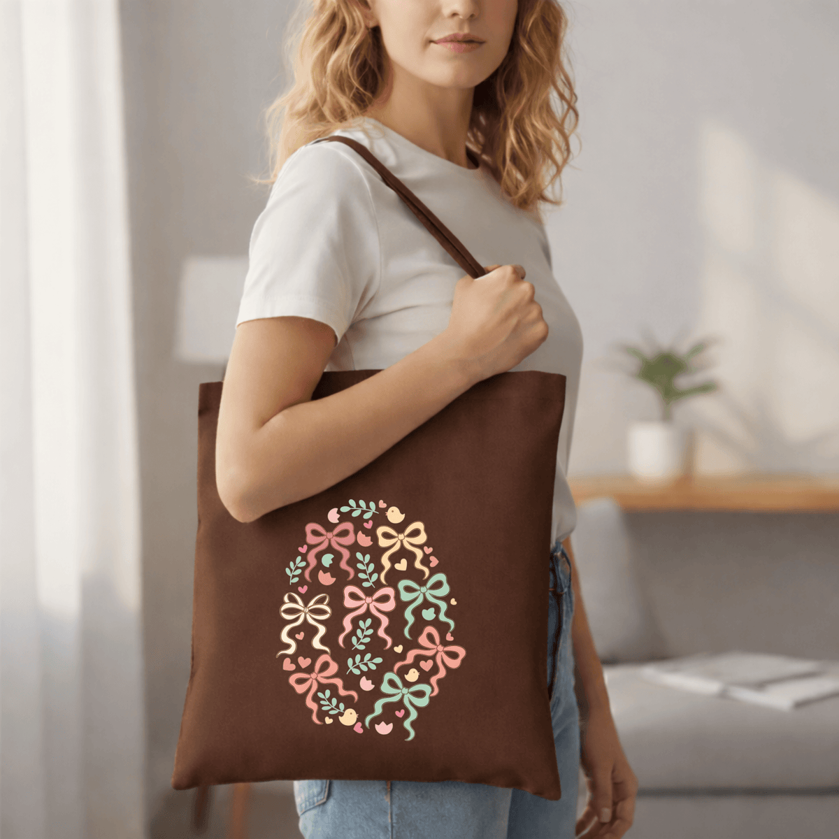 Woman holding a brown tote bag with decorative design in a living room setting