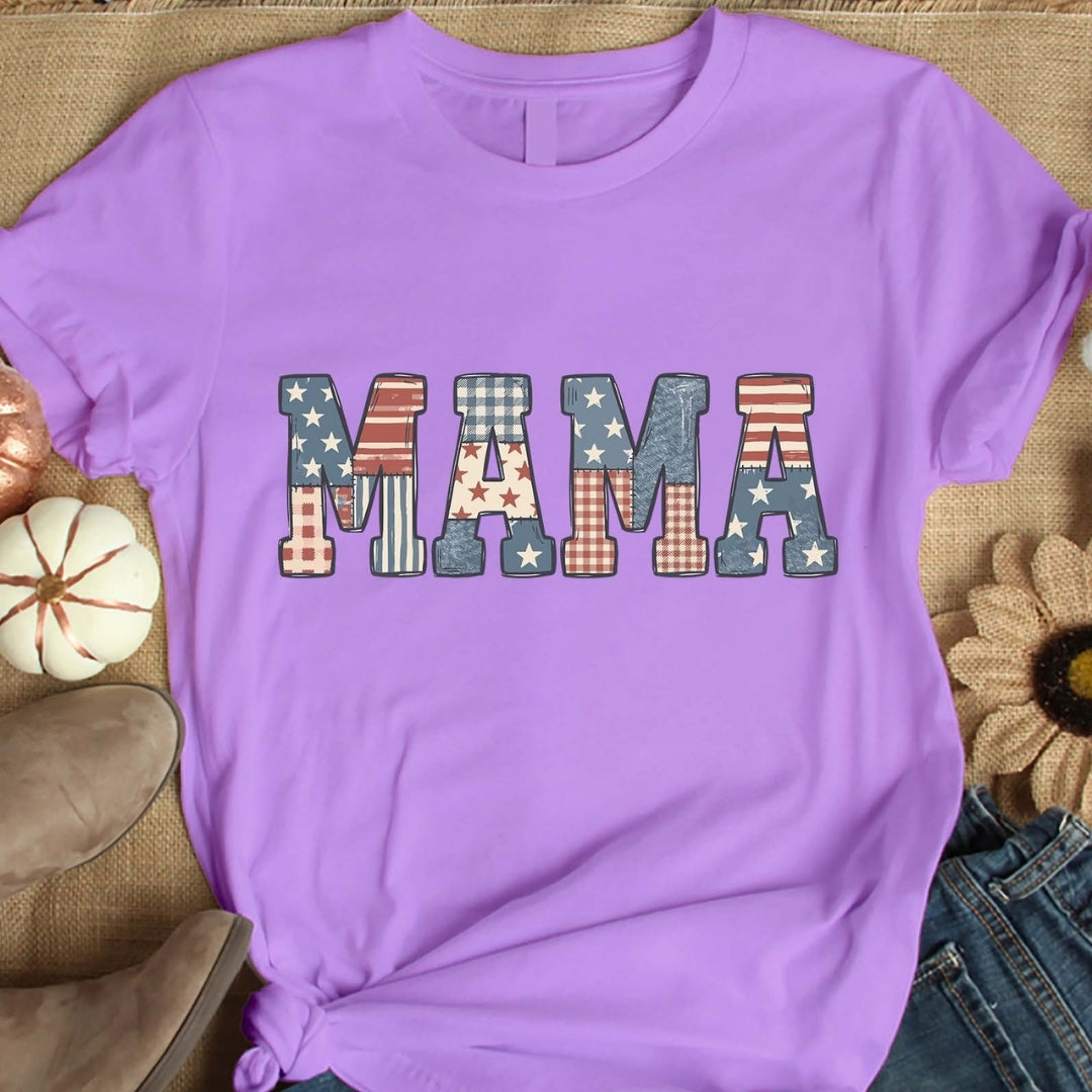 Purple t-shirt with 'MAMA' text in various patterns on a textured surface.
