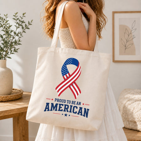 Tote bag with American flag ribbon design held by a person in a home setting