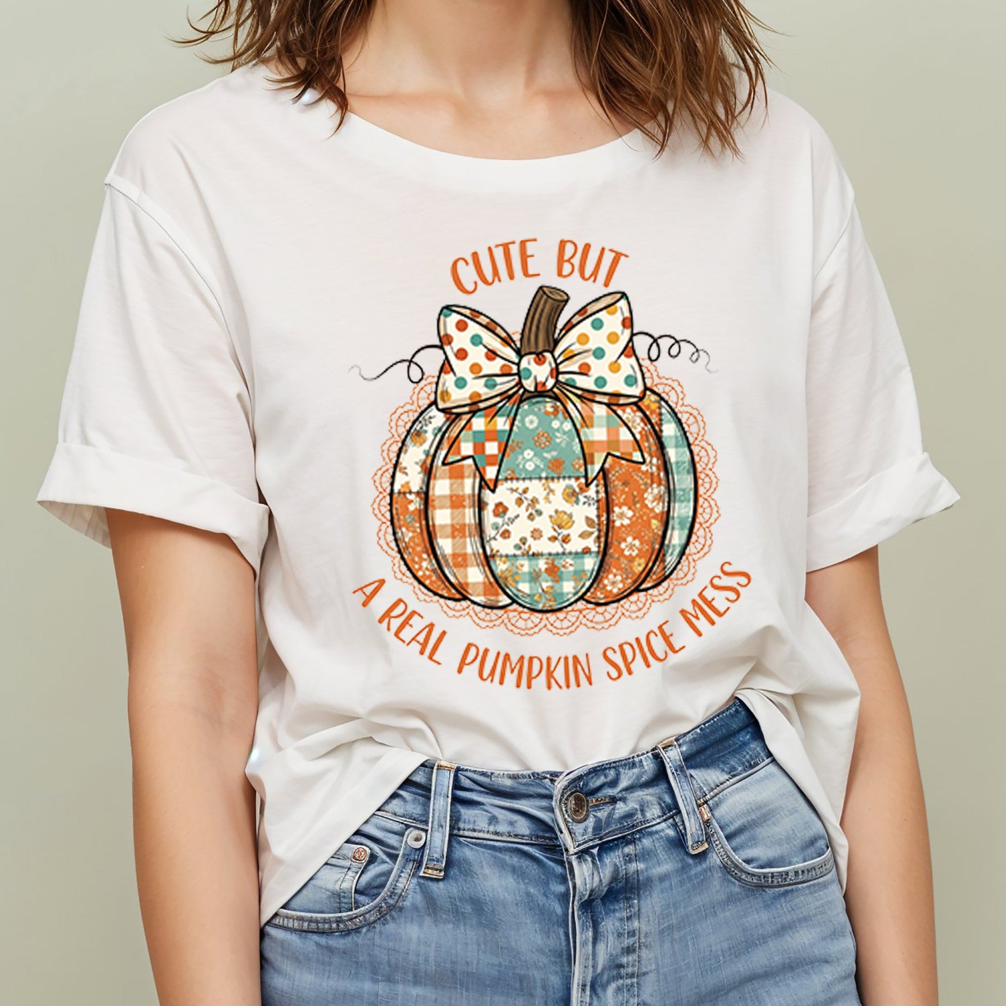 Person wearing a white t-shirt with a pumpkin graphic and text.