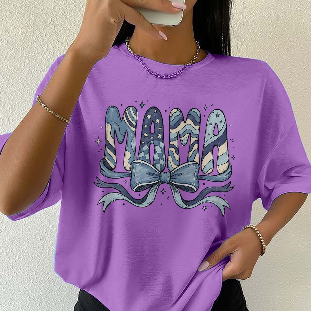 Person wearing a purple t-shirt with 'MAMA' and a bow design.