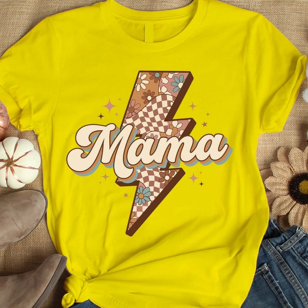 Yellow t-shirt with 'Mama' design on a textured surface