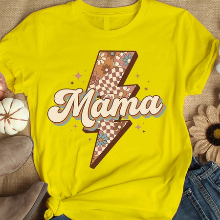 Yellow t-shirt with 'Mama' design on a textured surface