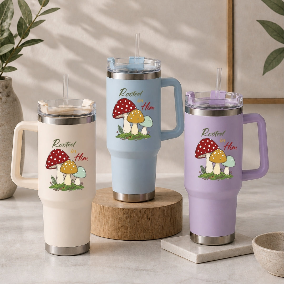 Three insulated travel mugs with mushroom design on a neutral background