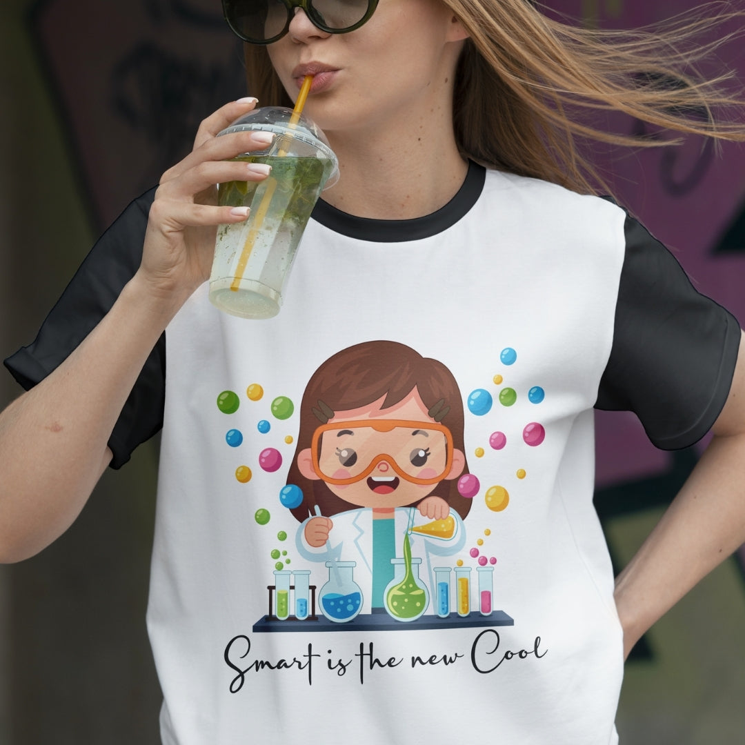 Person wearing a t-shirt with a cartoon character and text, holding a drink.
