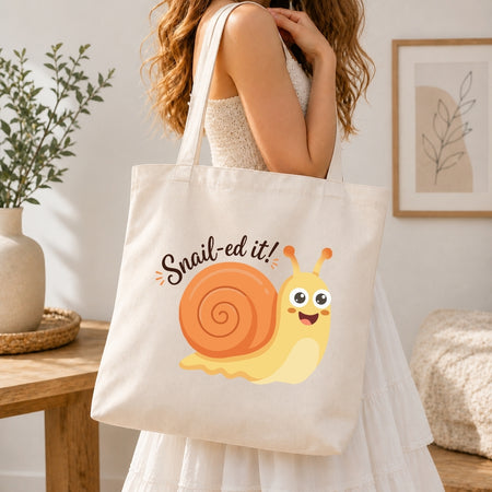 Person holding a tote bag with a snail design and text in a home setting