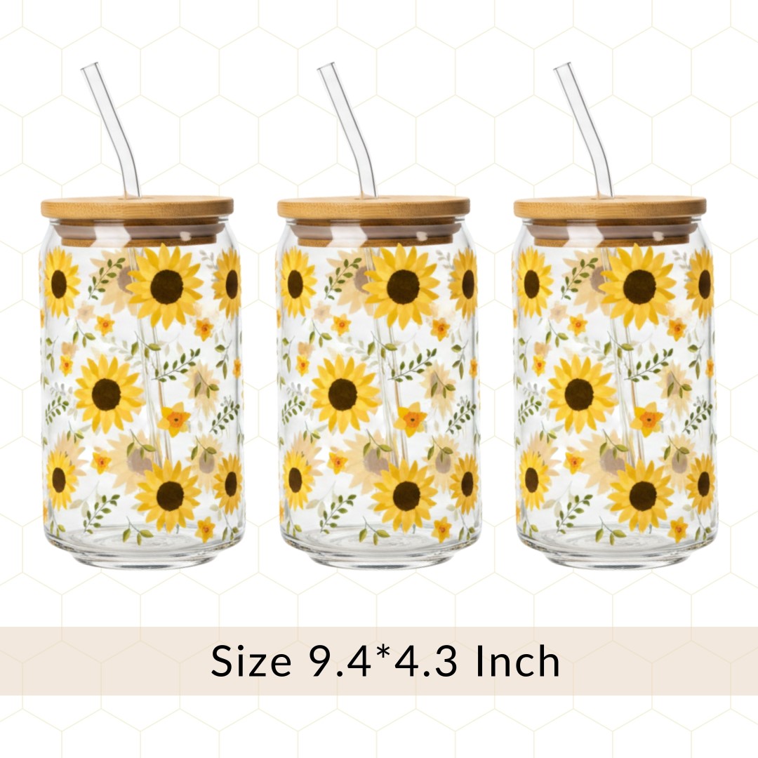Three glass jars with sunflower designs, bamboo lids, and straws on a white background.