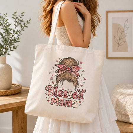 Person holding a tote bag with 'Blessed Mama' design in a home setting