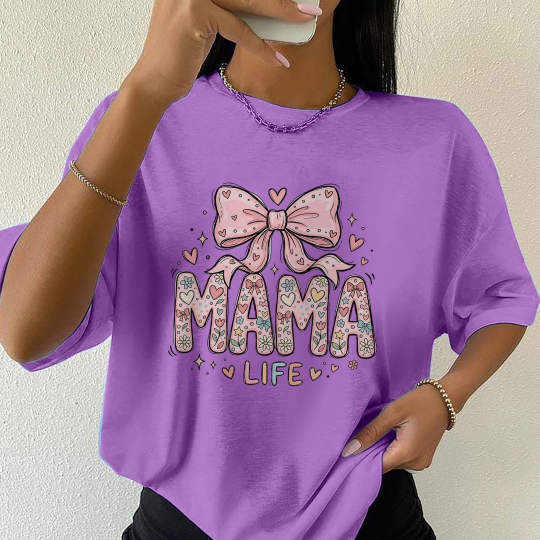 Person wearing a purple t-shirt with 'MAMA LIFE' and a bow graphic.