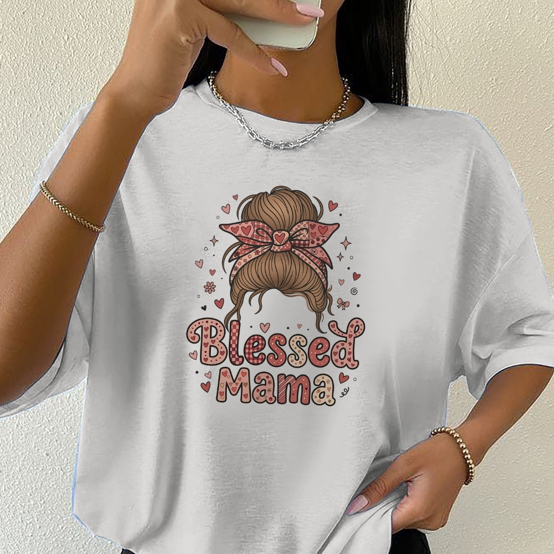 White t-shirt with 'Blessed Mama' design featuring a hairstyle and hearts, worn by a person.
