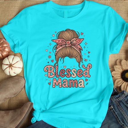 Turquoise t-shirt with 'Blessed Mama' design featuring a hairstyle and bow on a textured surface.