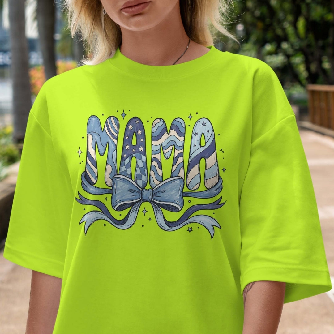 Person wearing a bright green t-shirt with 'Mama' design outdoors.