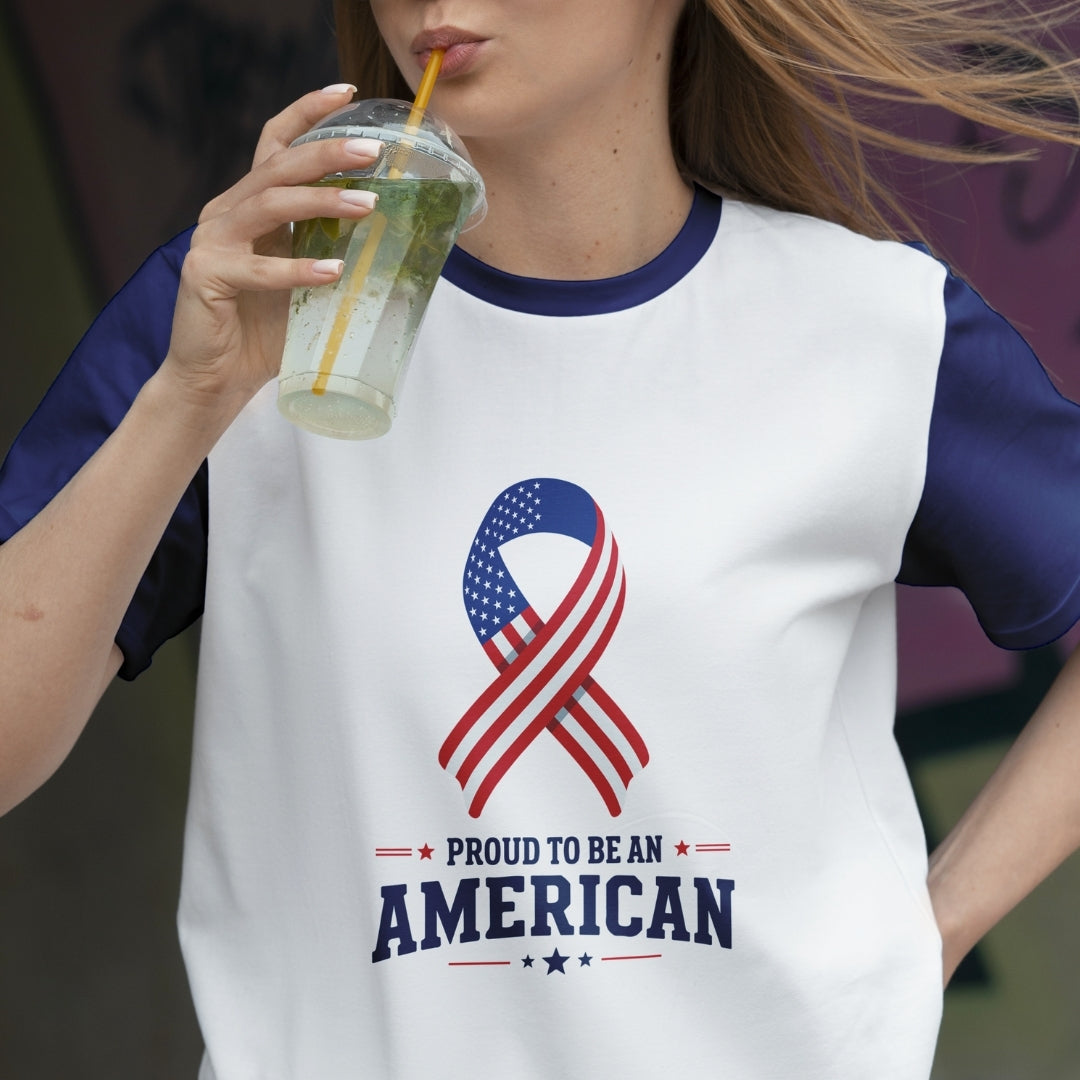 Person wearing a t-shirt with an American flag design and text, holding a drink.