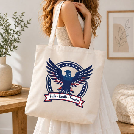 Person holding a tote bag with an eagle design and text indoors.